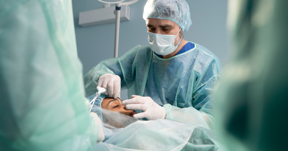 A surgeon performing surgery on a patient in the operating room.