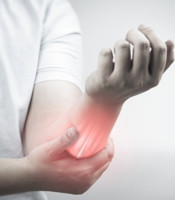 A man holding his hand due to arm pain.